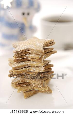 Stack of star shaped cookies, snowman and a cup of coffee in the background View Large Photo Image Stock Photograph - Stack of star shaped cookies, snowman and a cup of coffee in the background. Fotosearch