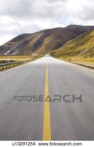 Picture - China, Ruoergai Grassland, Empty highway road on hillside. Fotosearch