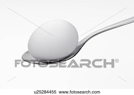 Stock Photography - Quail egg on spoon. Fotosearch