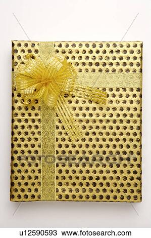 Stock Image - Close-up of a wrapped gift with beautiful packaging. Fotosearch