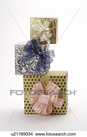 Picture - Close-up of three wrapped gifts with beautiful packaging. Fotosearch