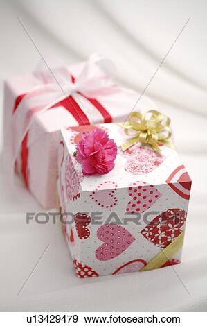 Stock Photo - Close-up of two wrapped gifts with beautiful packaging. Fotosearch