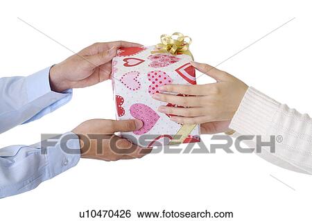Stock Photograph - Man giving a wrapped gift to woman. Fotosearch