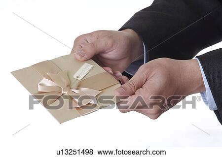 Stock Photo - Man holding a greeting card with bowknot. Fotosearch