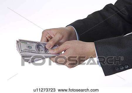 Man holding a stack of paper money View Large Photo Image Stock Image - Man holding a stack of paper money. Fotosearch