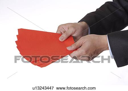 Man holding several red envelopes View Large Photo Image Stock Photo - Man holding several red envelopes. Fotosearch