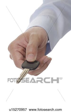 Stock Photo - Man's hand holding a key, close-up. Fotosearch