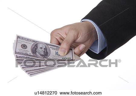 Stock Image - Man's hand holding a stack of paper money. Fotosearch