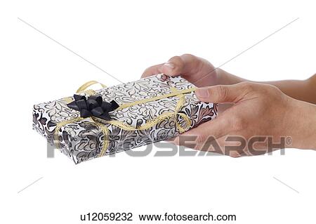 Man's hands holding a wrapped gift View Large Photo Image Stock Image - Man's hands holding a wrapped gift. Fotosearch