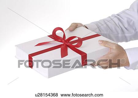 Stock Photo - Man's hands holding a wrapped gift. Fotosearch