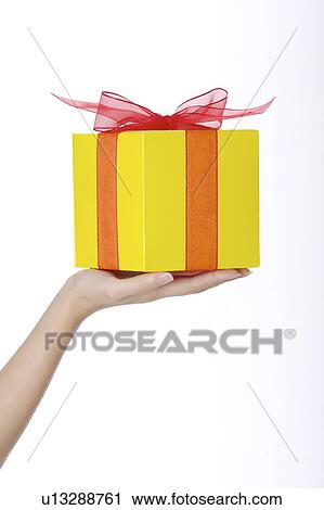 Woman's hand holding a wrapped gift View Large Photo Image Stock Image - Woman's hand holding a wrapped gift. Fotosearch