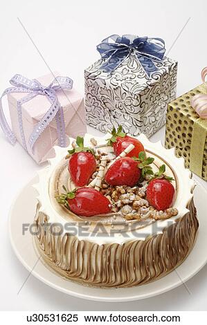 Close-up of a birthday cake and three wrapped gifts View Large Photo Image Stock Photography - Close-up of a birthday cake and three wrapped gifts. Fotosearch