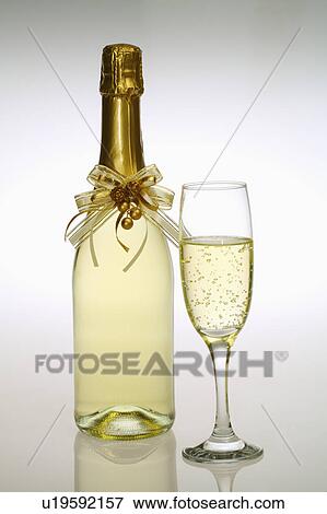Stock Photo - Close-up of a bottle and a glass of champagne. Fotosearch
