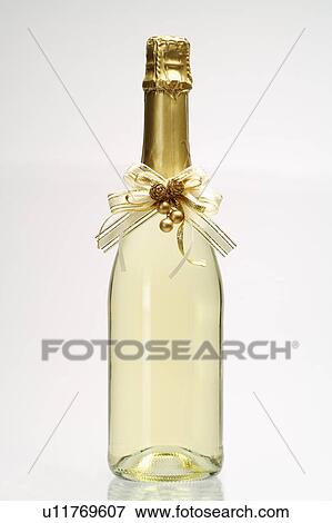 Close-up of a bottle of champagne with bowknot View Large Photo Image Stock Photo - Close-up of a bottle of champagne with bowknot. Fotosearch