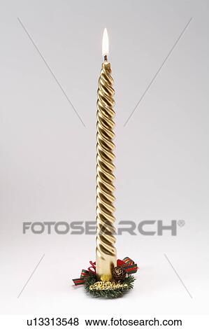 Stock Photo - Close-up of a golden candle. Fotosearch