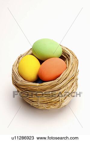 Stock Image - Close-up of three Easter eggs in a nest. Fotosearch