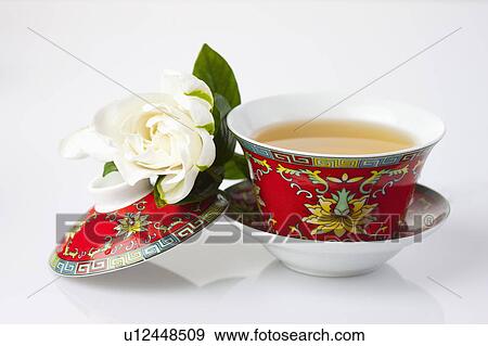 Close-up of a cup of tea and a camellia View Large Photo Image Stock Photo - Close-up of a cup of tea and a camellia. Fotosearch