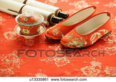 "Close-up of a pair of Chinese sandals, a cup of tea and two scrolls" View Large Photo Image Stock Image - "Close-up of a pair of Chinese sandals, a cup of tea and two scrolls". Fotosearch