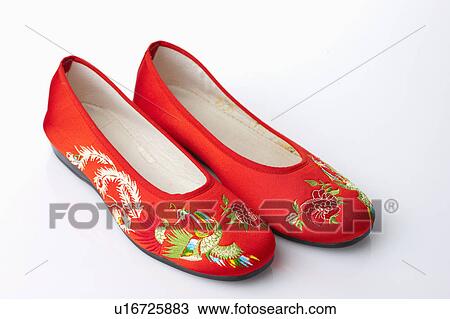 Stock Image - Close-up of a pair of Chinese sandals with lucky pattern. Fotosearch