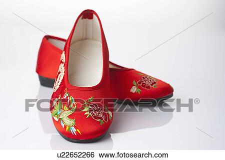 Stock Photograph - Close-up of a pair of Chinese sandals with lucky pattern. Fotosearch