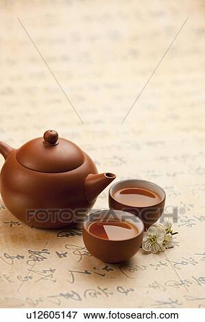 Close-up of a teapot and two cups of tea on calligraphy View Large Photo Image Stock Photo - Close-up of a teapot and two cups of tea on calligraphy. Fotosearch