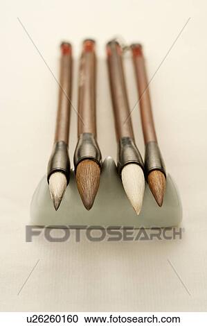 Stock Image - "Close-up of four ink brushes on the penholder, in a row". Fotosearch