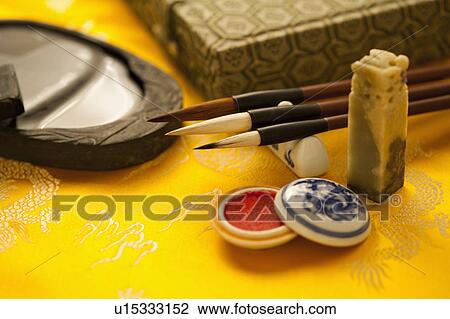 "Close-up of inkpad, ink brushes and inkstone on textile with lucky pattern" View Large Photo Image Stock Image - "Close-up of inkpad, ink brushes and inkstone on textile with lucky pattern". Fotosearch