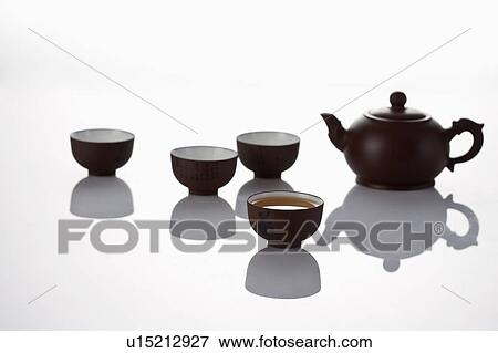 Stock Photo - Close-up of teapot and four tea cups of Chinese style. Fotosearch