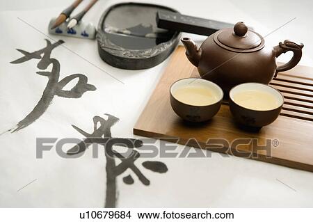 "Close-up of teapot, two cups of tea and calligraphy" View Large Photo Image Picture - "Close-up of teapot, two cups of tea and calligraphy". Fotosearch