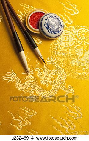 Close-up of two ink brushes and inkpad on textile with lucky pattern View Large Photo Image Picture - Close-up of two ink brushes and inkpad on textile with lucky pattern. Fotosearch