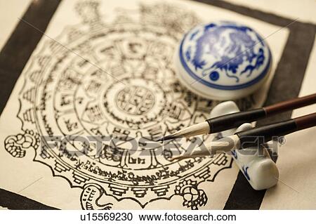 Stock Image - Close-up of two ink brushes and inkpad of Chinese style. Fotosearch