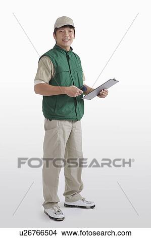 Delivery-person holding a clipboard View Large Photo Image Picture - Delivery-person holding a clipboard. Fotosearch