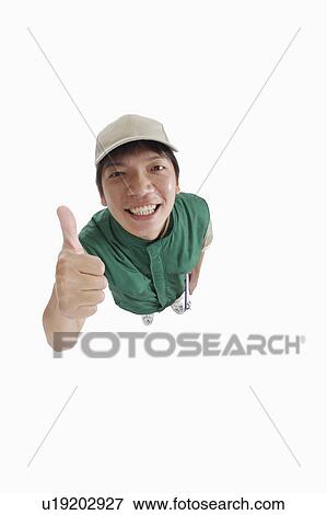 Delivery person with thumbs up and looking at the camera View Large Photo Image Stock Photo - Delivery person with thumbs up and looking at the camera. Fotosearch