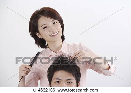 Female hairdresser holding comb and young man's hair View Large Photo Image Stock Photograph - Female hairdresser holding comb and young man's hair. Fotosearch