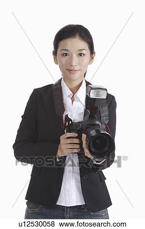Stock Photo - "Female photographer holding camera, portrait". Fotosearch