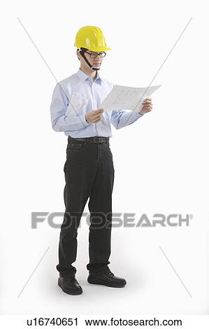 Male engineer looking at blueprint View Large Photo Image Stock Image - Male engineer looking at blueprint. Fotosearch