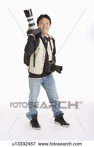Male photographer carrying camera on shoulder and one on chest View Large Photo Image Stock Photo - Male photographer carrying camera on shoulder and one on chest. Fotosearch
