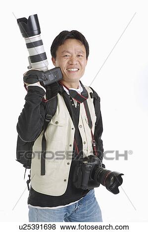 Male photographer smiling happily with two cameras View Large Photo Image Stock Photo - Male photographer smiling happily with two cameras. Fotosearch