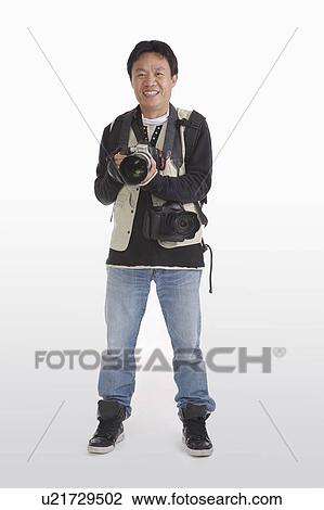 Stock Image - Photographer holding camera to take pictures. Fotosearch