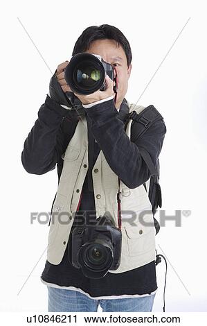 Stock Image - Photographer taking pictures with camera. Fotosearch