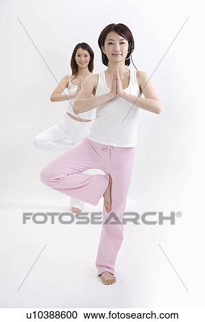 Young female coach doing yoga with young woman View Large Photo Image Stock Image - Young female coach doing yoga with young woman. Fotosearch