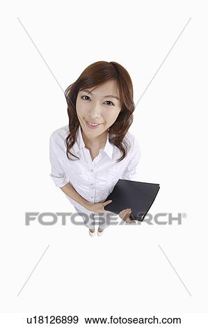 Stock Photo - Young female journalist holding a clipboard and looking at the camera. Fotosearch