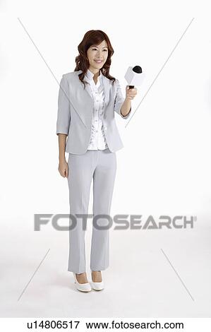 Young female journalist holding microphone View Large Photo Image Stock Photo - Young female journalist holding microphone. Fotosearch