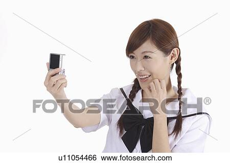 Young female student taking picture by herself View Large Photo Image Stock Photograph - Young female student taking picture by herself. Fotosearch
