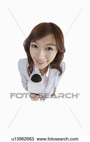 "Young female TV reporter holding microphone, portrait" View Large Photo Image Stock Image - "Young female TV reporter holding microphone, portrait". Fotosearch
