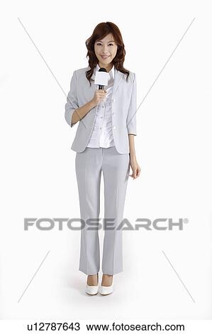 Young female TV reporter making broadcasting and smiling at the camera View Large Photo Image Stock Image - Young female TV reporter making broadcasting and smiling at the camera. Fotosearch