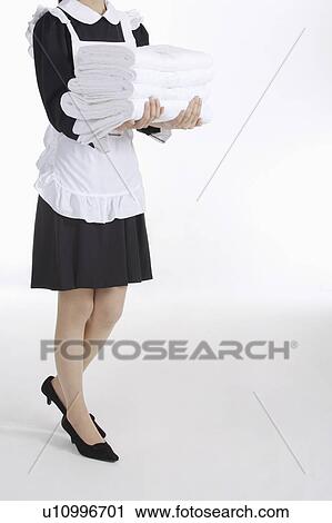 Young waitress holding a stack of towels View Large Photo Image Stock Image - Young waitress holding a stack of towels. Fotosearch