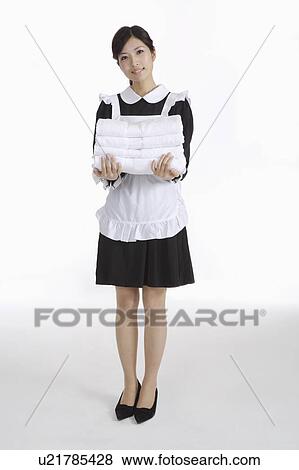Young waitress holding a stack of towels View Large Photo Image Stock Photo - Young waitress holding a stack of towels. Fotosearch