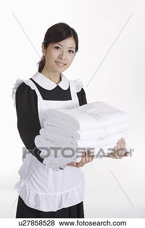 Young waitress holding a stack of towels View Large Photo Image Stock Photo - Young waitress holding a stack of towels. Fotosearch