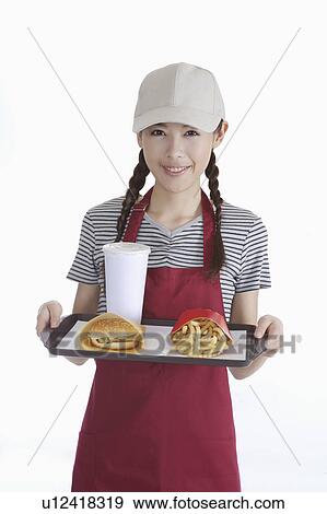 Stock Photo - "Young waitress holding fast food on the tray, portrait". Fotosearch